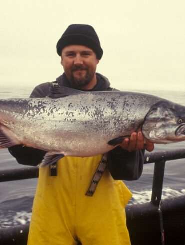 man carrying silver fish