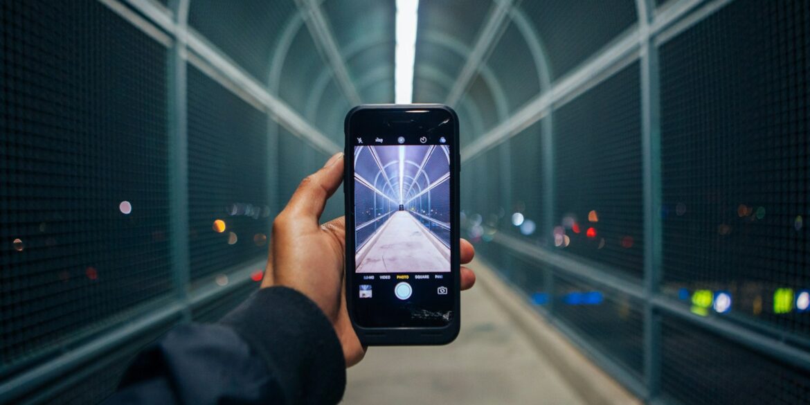 person holding phone showing empty tunnel