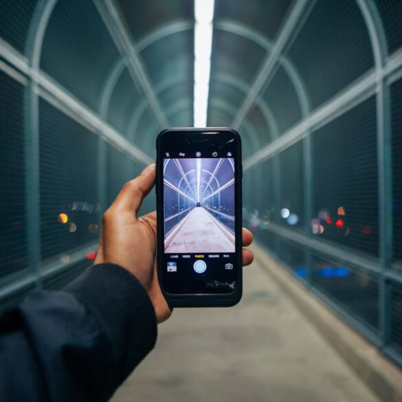 person holding phone showing empty tunnel