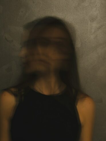 a blurry photo of a woman in a black top