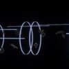 a black wall with a neon light drawing on it