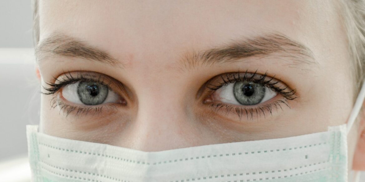 closeup photo of woman's eye wearing mask