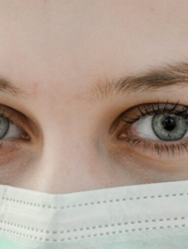 closeup photo of woman's eye wearing mask
