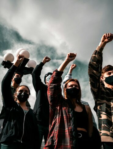 group of people raising their hands