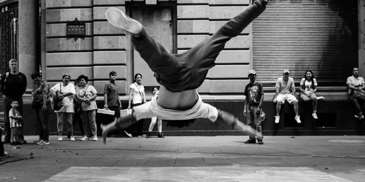 jumping man in grayscale photography