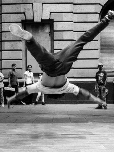 jumping man in grayscale photography
