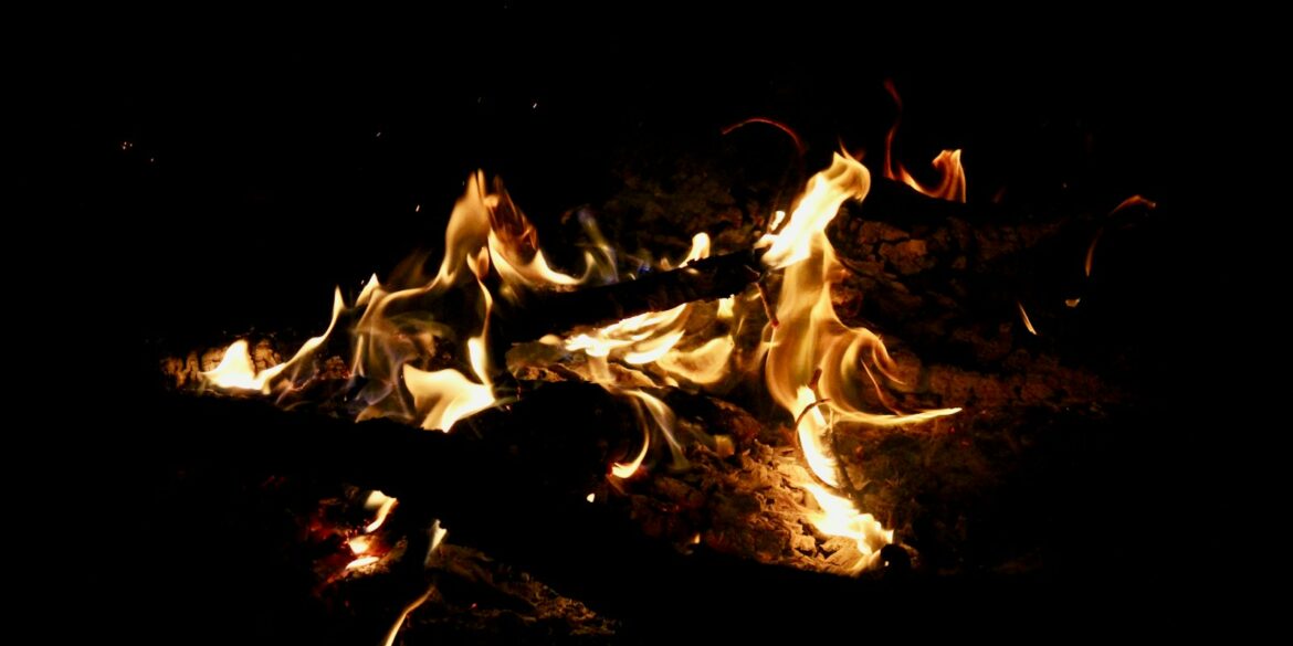 a close up of a fire in the dark