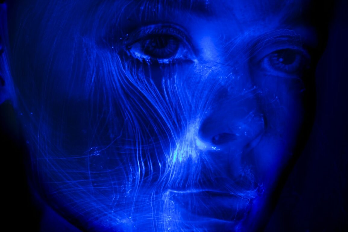 womans face with blue light