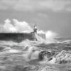 grayscale photo of sea waves crashing on concrete wall