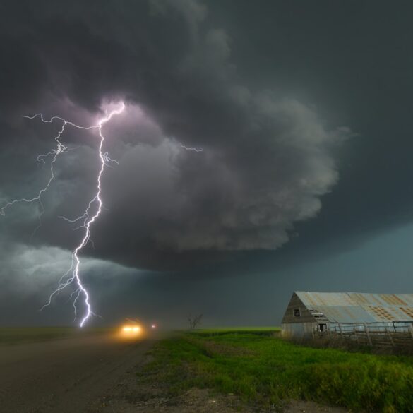 a lightning bolt hitting over a farm in the country