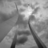 a plane flying over a large tower