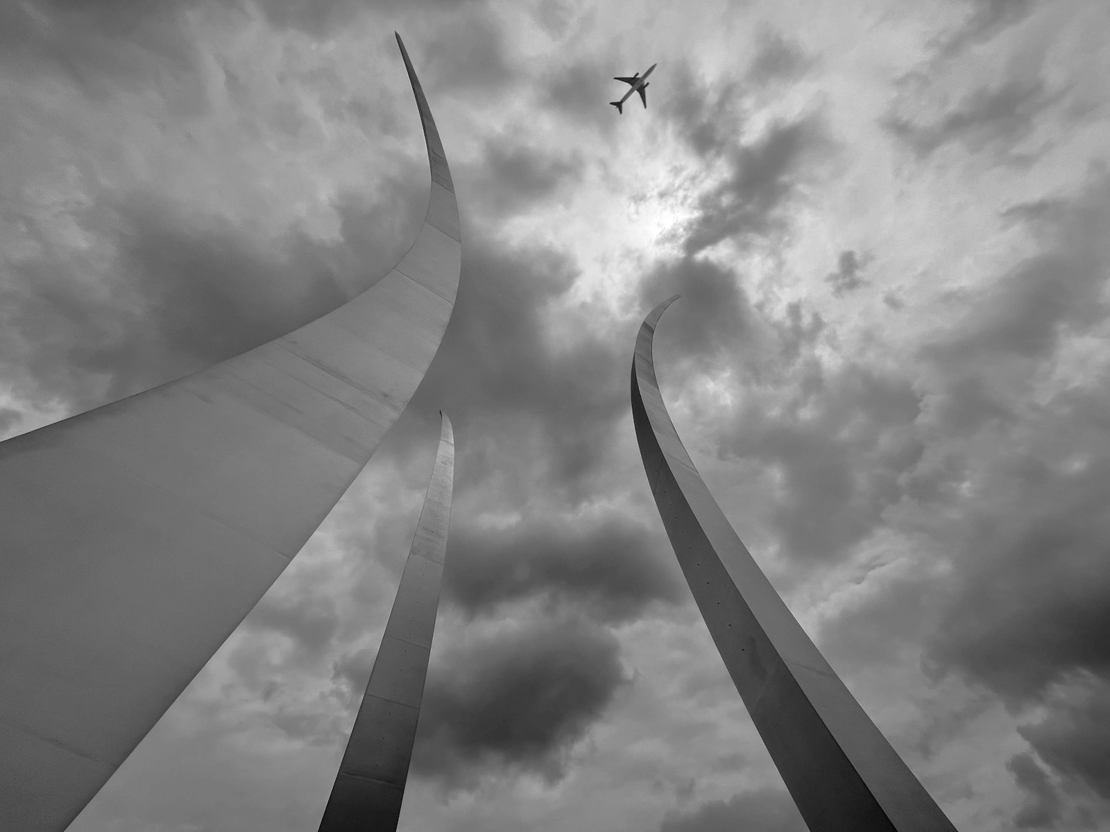 a plane flying over a large tower