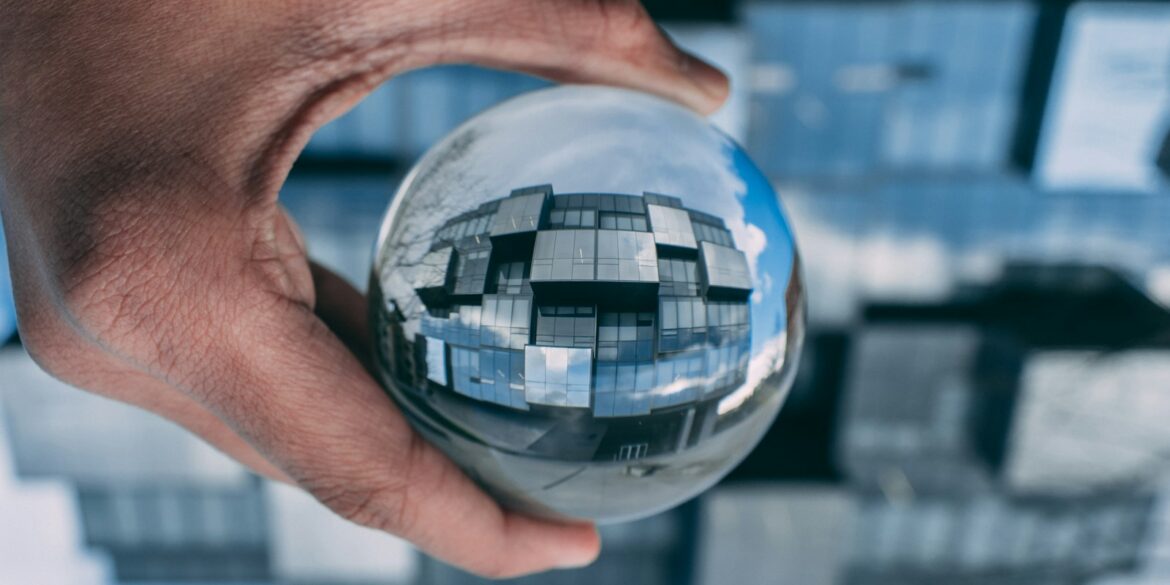 person holding a clear glass ball