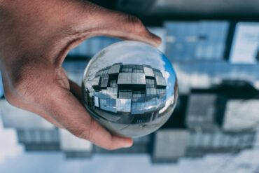 person holding a clear glass ball