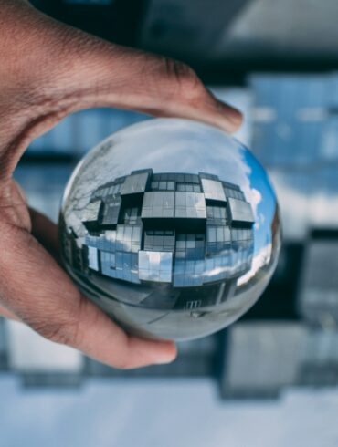 person holding a clear glass ball