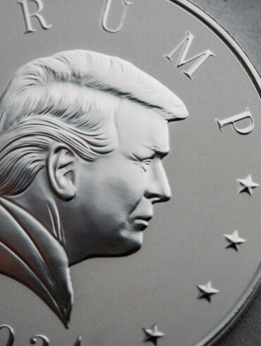 a close up of a silver coin with a picture of president donald