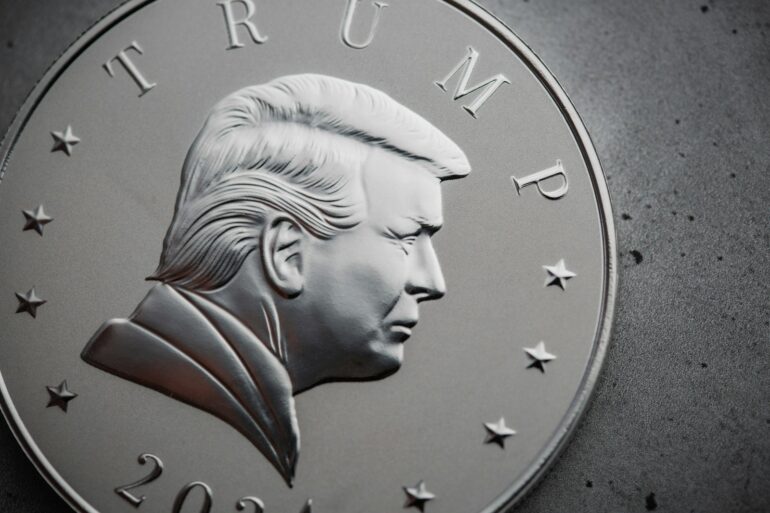 a close up of a silver coin with a picture of president donald