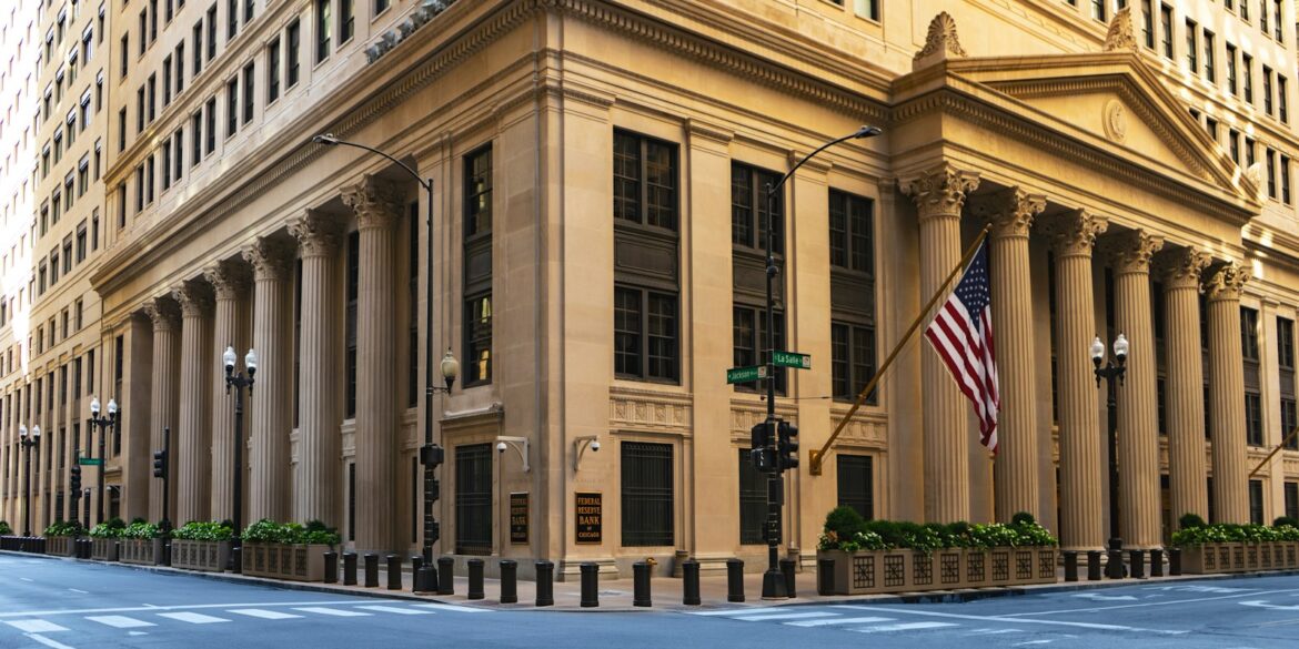 a large building with columns and a flag on the corner