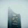 a very tall building in the middle of a foggy day