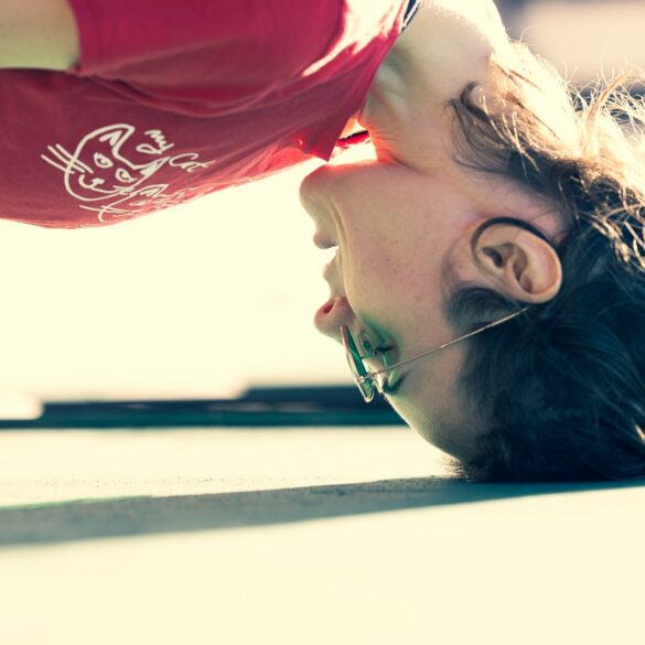 woman in red and white shirt wearing gold framed eyeglasses