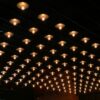 A room with a lot of lights hanging from the ceiling