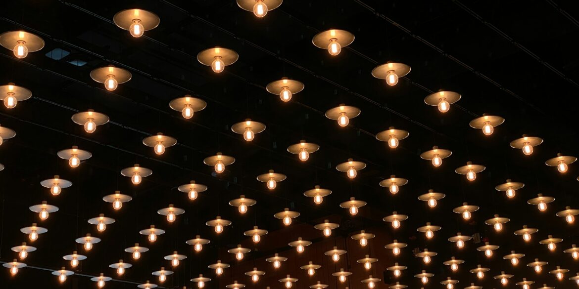 A room with a lot of lights hanging from the ceiling