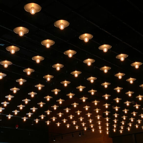 A room with a lot of lights hanging from the ceiling