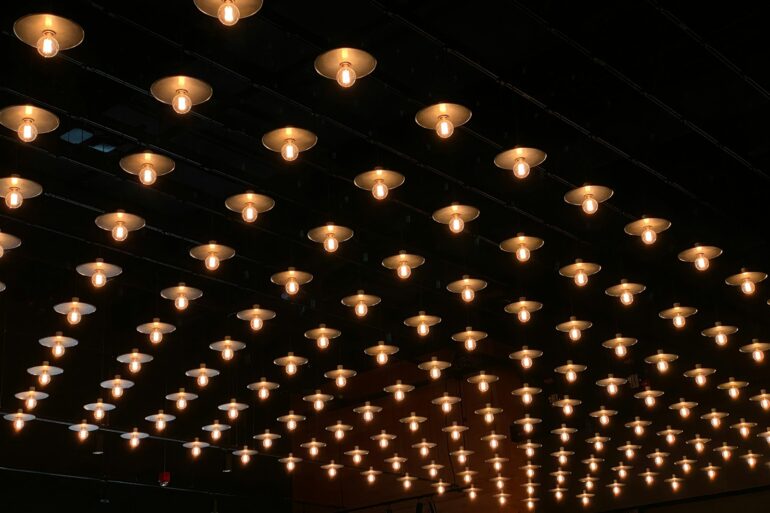 A room with a lot of lights hanging from the ceiling