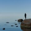 man standing on brown rock