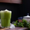 green liquid in clear drinking glass