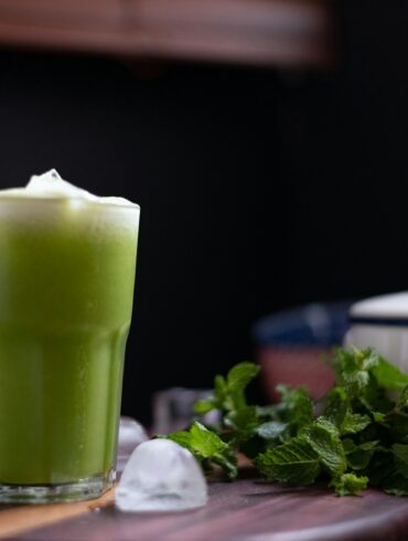 green liquid in clear drinking glass