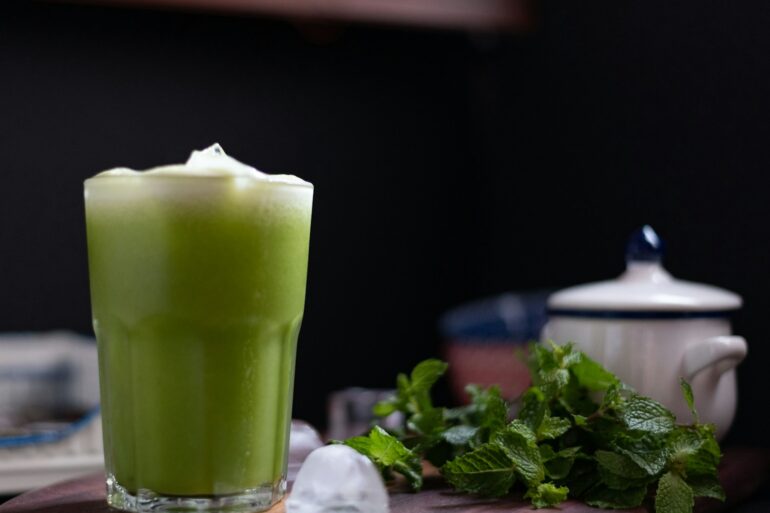 green liquid in clear drinking glass