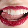 person with red lipstick and white teeth