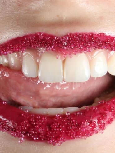 person with red lipstick and white teeth