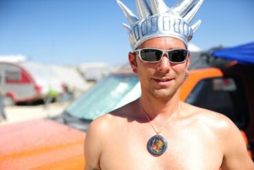 man wearing black sunglasses and silver crown