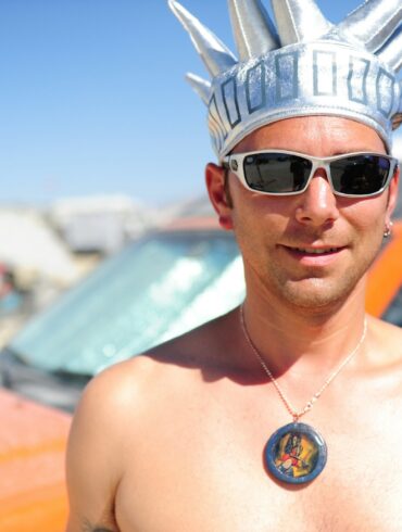 man wearing black sunglasses and silver crown
