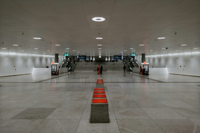 people walking on white floor tiles