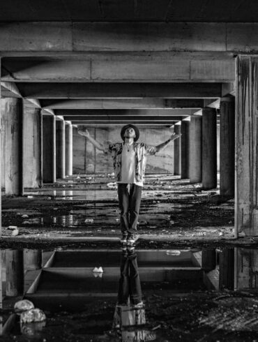 a man standing in a tunnel with his arms outstretched