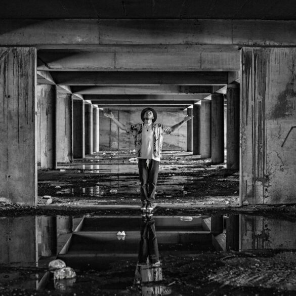 a man standing in a tunnel with his arms outstretched