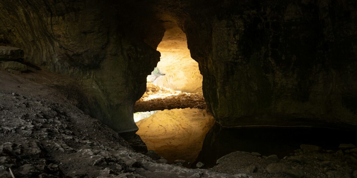 A cave with a light at the end of it