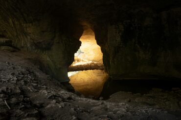 A cave with a light at the end of it