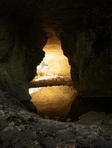 A cave with a light at the end of it