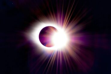 a solar eclipse is seen in the dark sky
