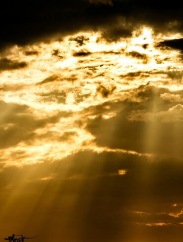 the sun is shining through the clouds in the sky