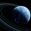 Blue planet with rings in outer space