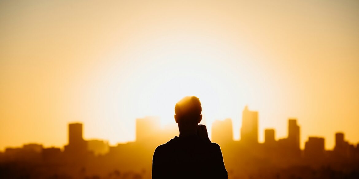 silhouette photography of standing person during sunset