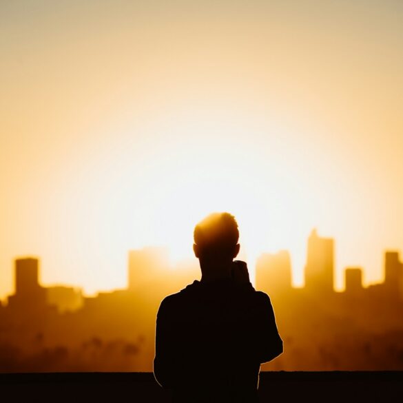 silhouette photography of standing person during sunset