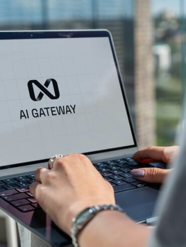 Person typing on laptop with ai gateway logo.
