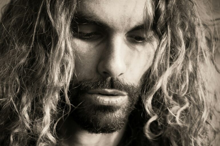 a man with long hair and a beard