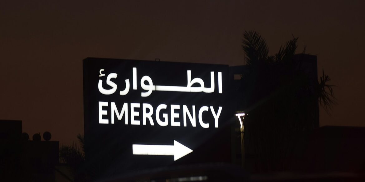Emergency sign with arabic text and arrow